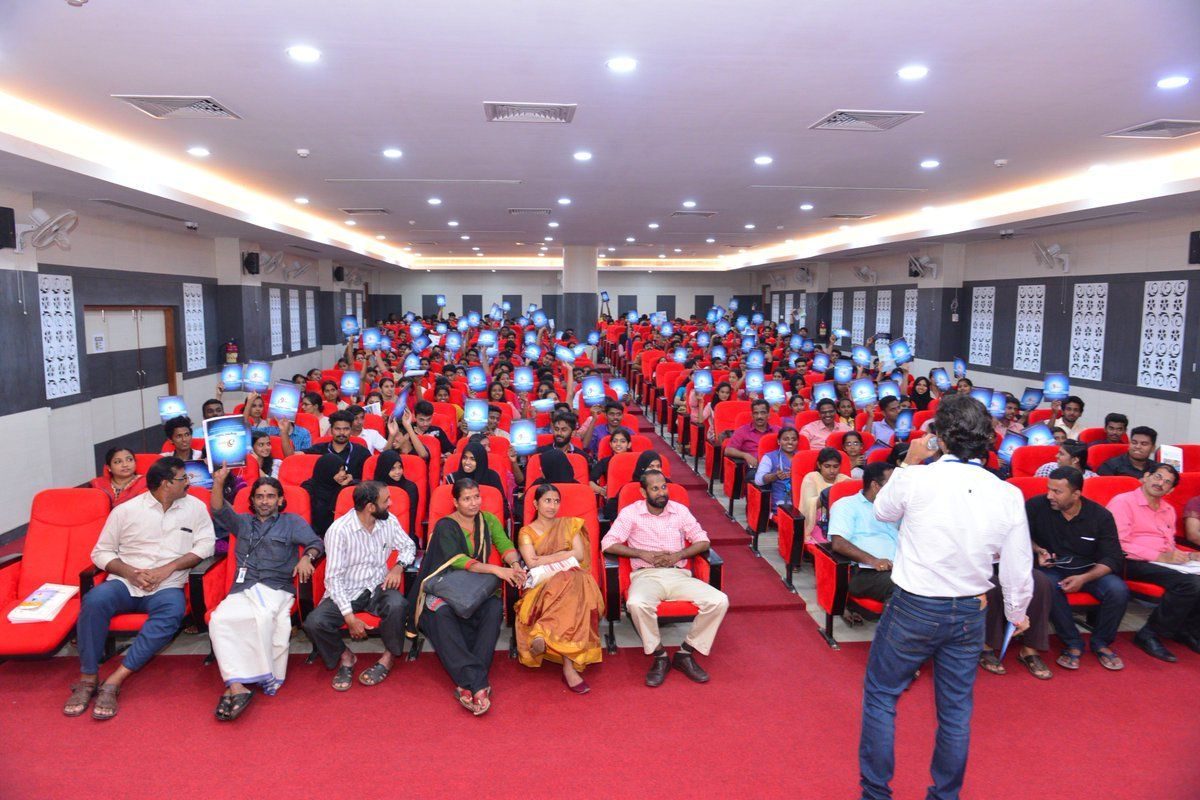 Santosh Talaghatti addressing a packed auditorium during a government training session in Kerala