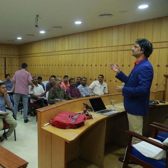 Santosh Talaghatti delivering a capacity-building training session to government officials